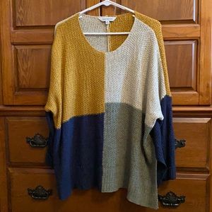Oversized Sweater w/ side slits. Mustard yellow, navy, green and cream colored.